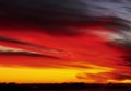 Setting sun sweeps across a paintbrush sky, Big Sur, California