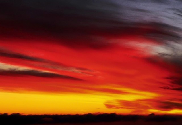 Setting sun sweeps across a paintbrush sky, Big Sur, California