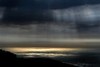 Golden sea and black clouds, Big Sur, California