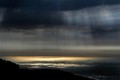 Golden sea and black clouds, Big Sur, California