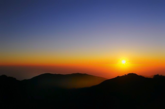 Sun sinks into lava sea, Big Sur, California