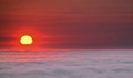 Yellow sun slips into fog, Big Sur, California