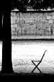 Empty chair in a Paris park, France