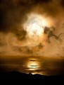 Sun burns through storm clouds, Big Sur, California