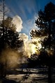 Sun setting behind Castle Geyser (color, #1), Yellowstone National Park, Wyoming