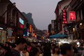 Crowds Fill Street at Dusk in Xingping