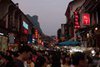 Crowds Fill Street at Dusk in Xingping