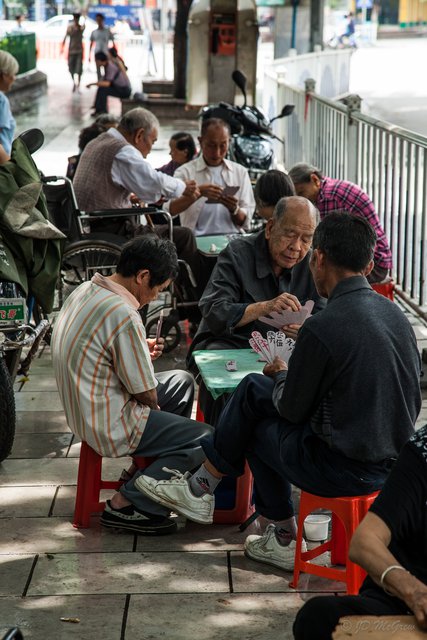 Men Playing Cards in Park Plaza