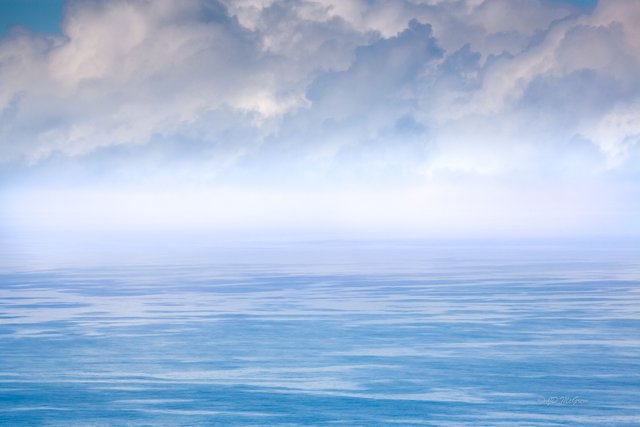 Clouds Hover Over Turquoise Sea