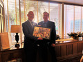 CEO Paul Cardus presents Jim Hamilton a photo collage, a remembrance of his year as president.