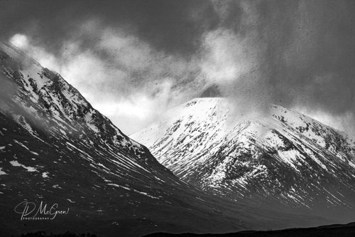 Snow Covered Mountains in Clouds