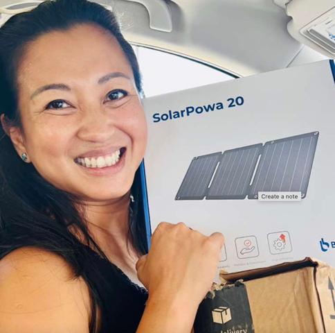 Kathy Ruszuka receiving the first shipment of solar power banks